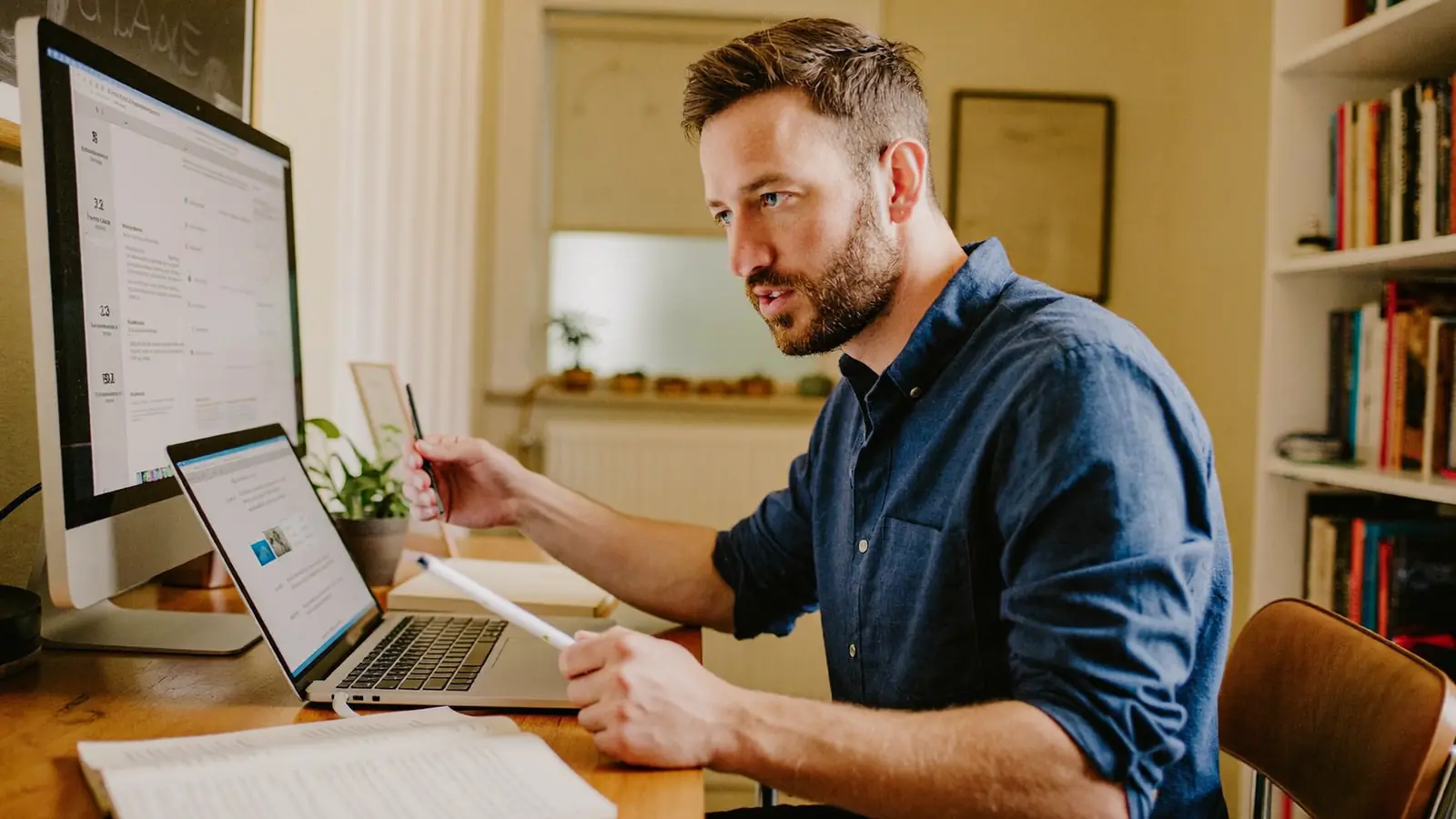 Homeowner comparing double glazing quotes on a laptop at home