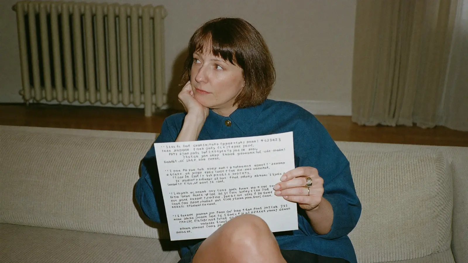 Homeowner reading a printed double glazing quote at home